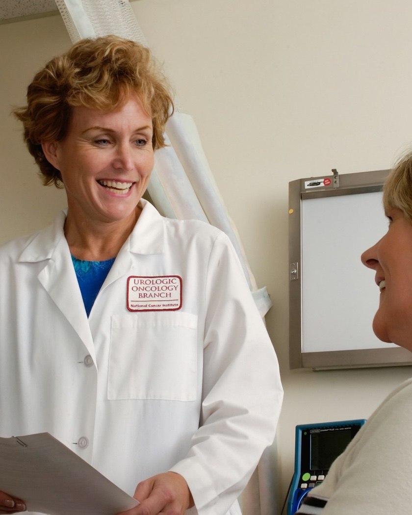 A physician talking with a colleague between patients